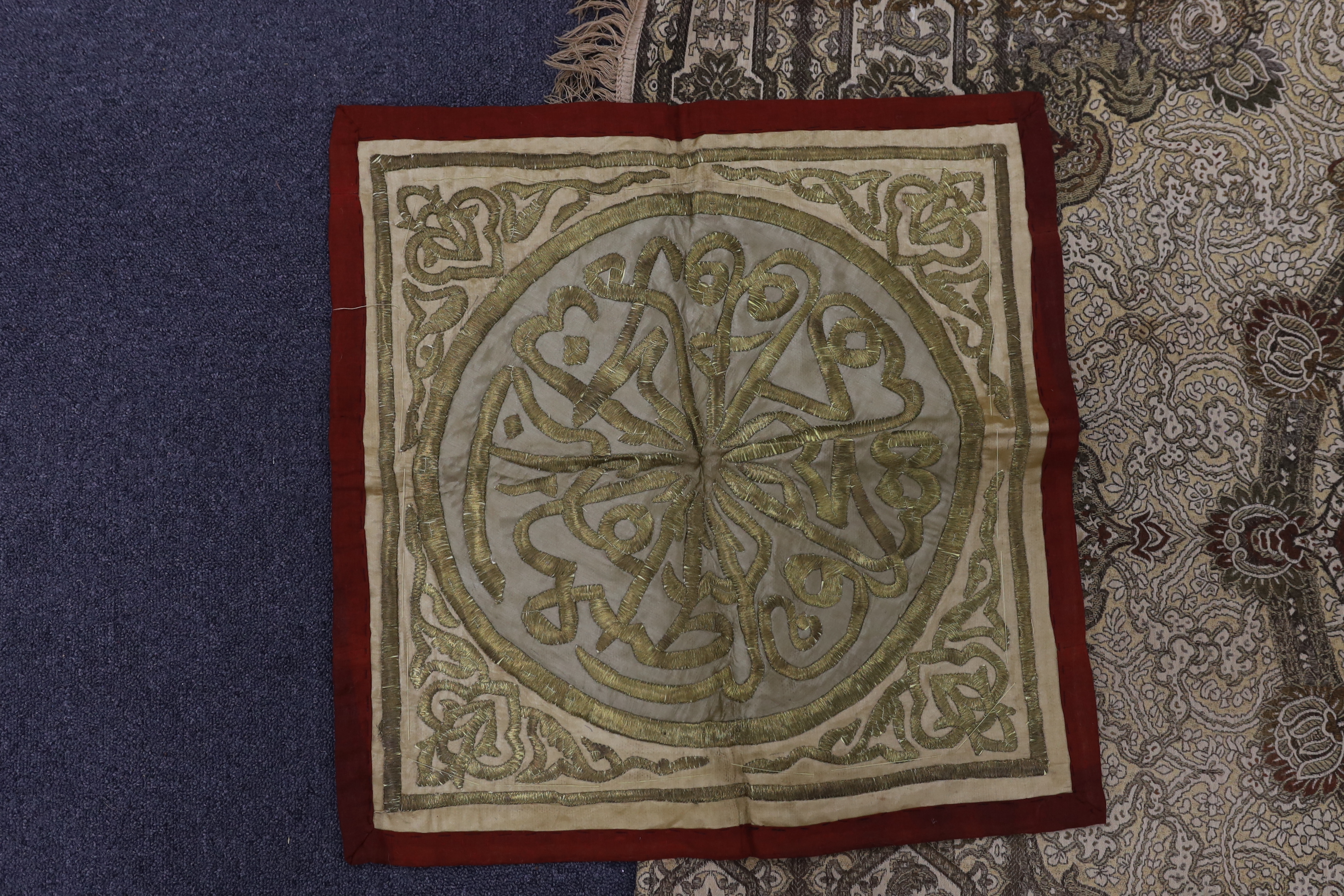 Two 19th century Indian heavy metallic thread embroideries on silk, another smaller similar panel and later 20th century machine woven fringed bedcover, two metal embroideries 53cm x 52cm